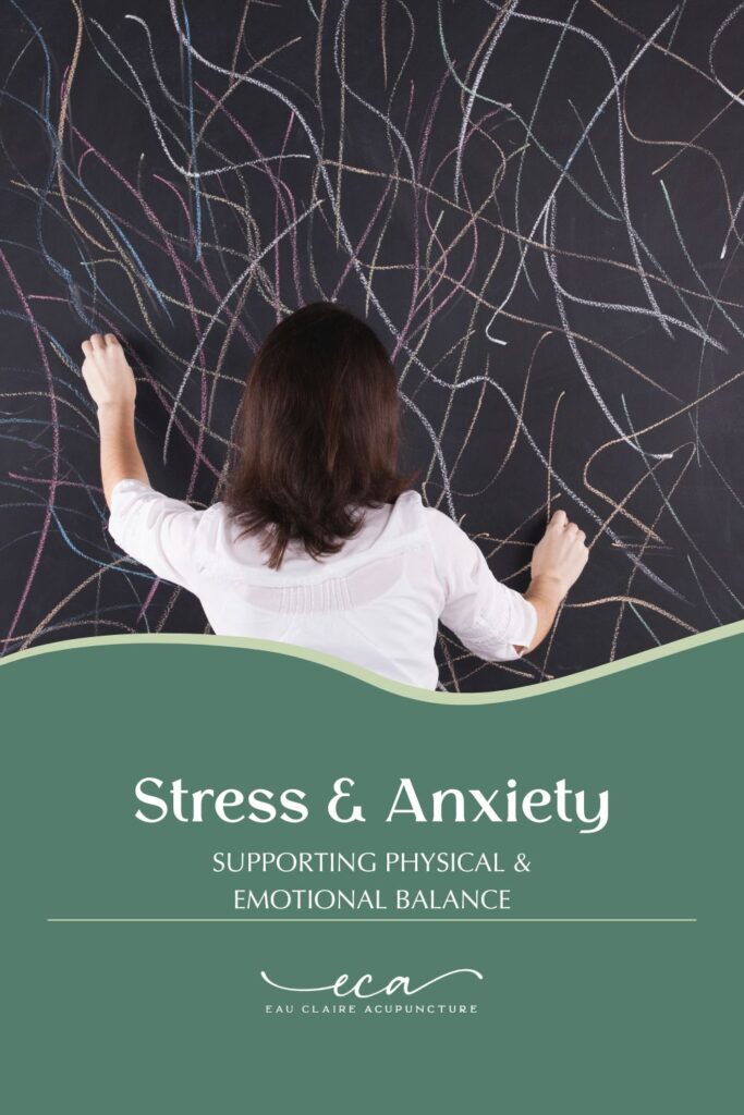 Woman scribbling lines all over a chalkboard in different colors. 