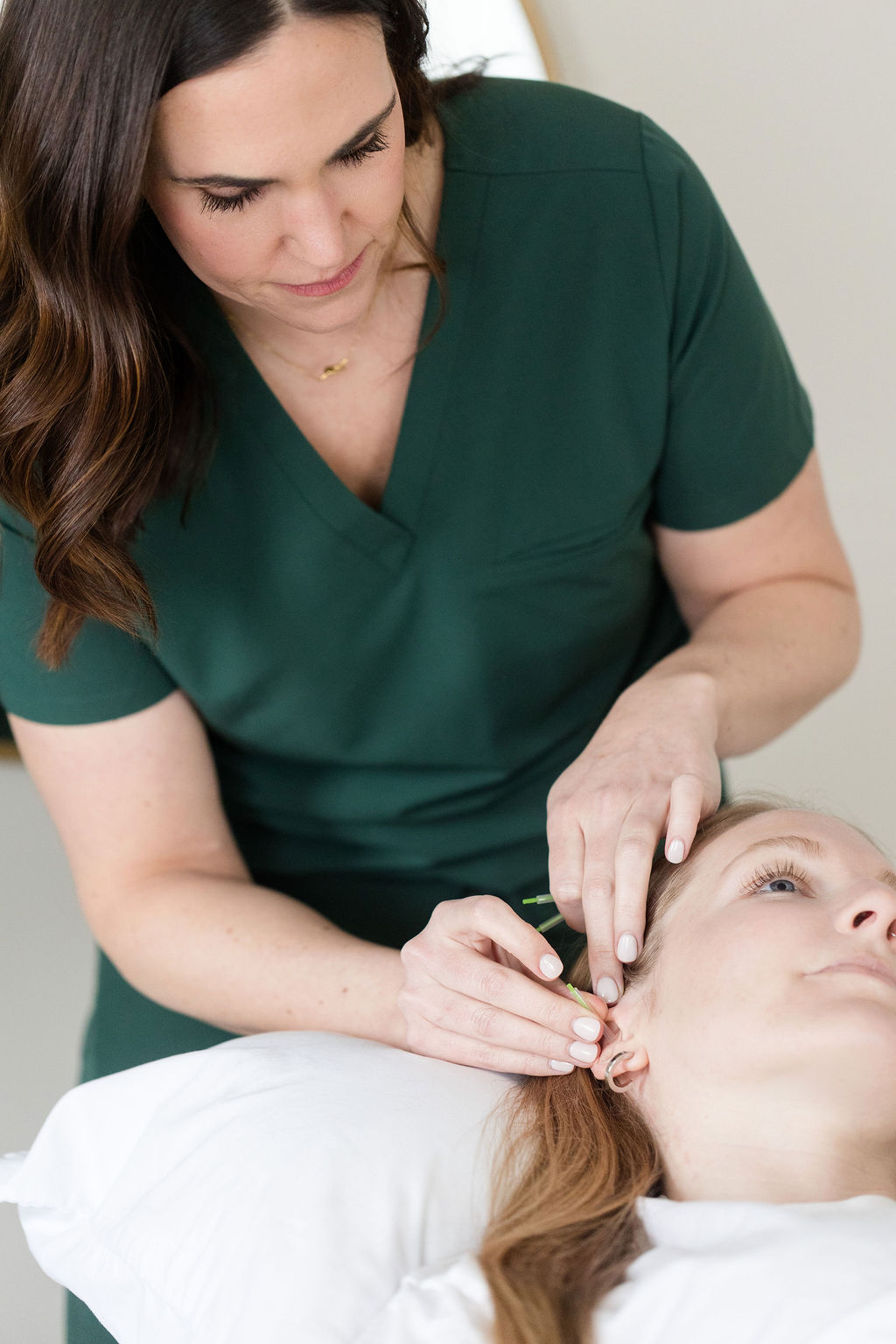 Jamie, a licensed acupuncturist, place acupuncture needles into auricular points for pain.