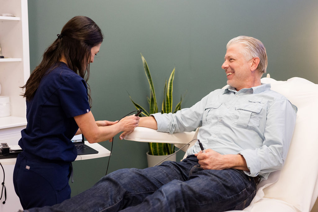 An acupuncturist does a TCM exam on a male fertility patient.